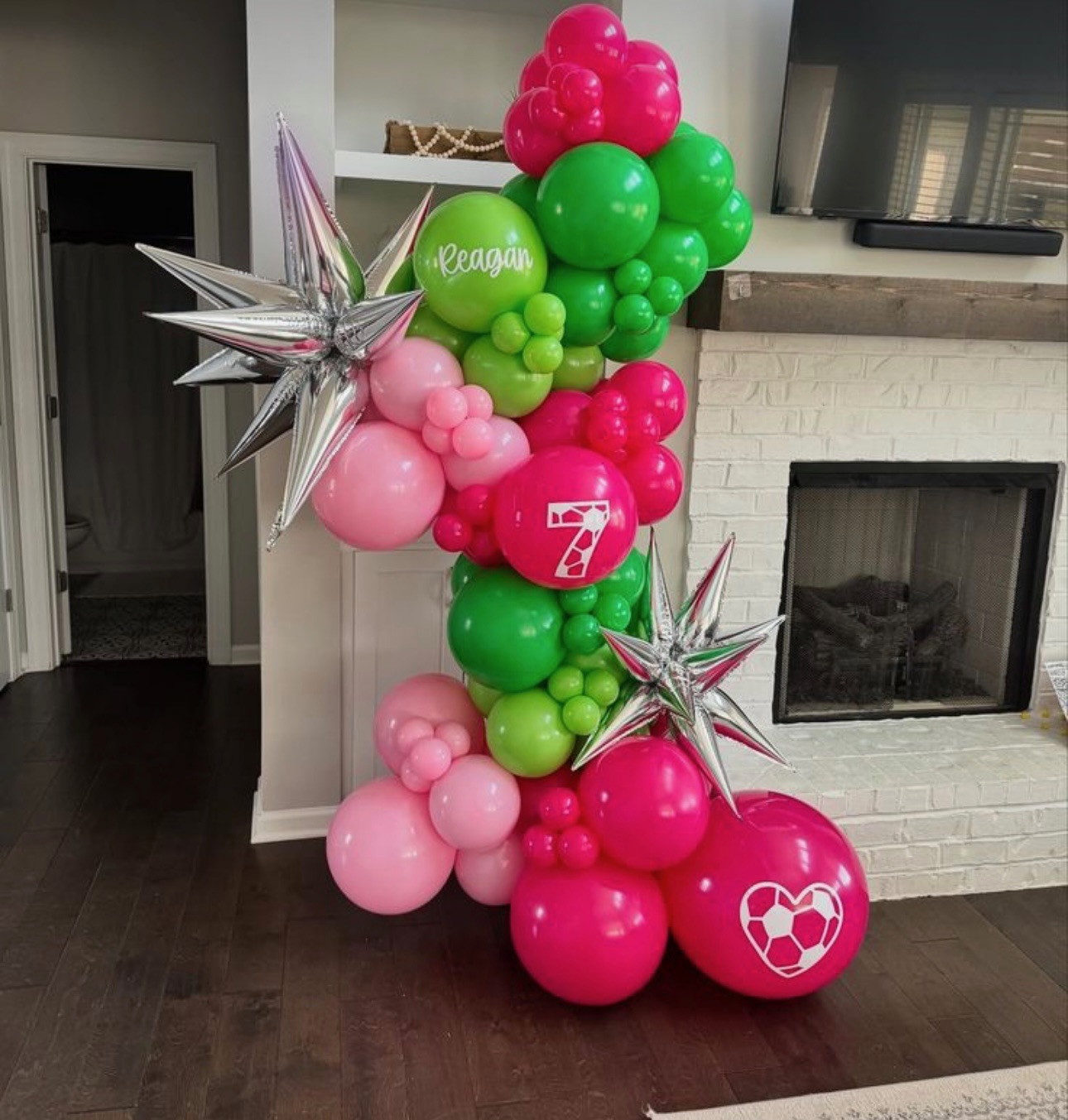 Pink, green, and silver organic balloon garland with starburst foil accents