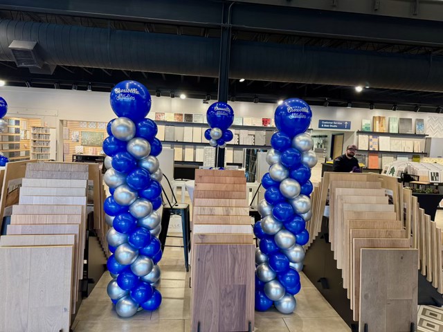 Blue and silver chrome balloon columns at a corporate showroom event