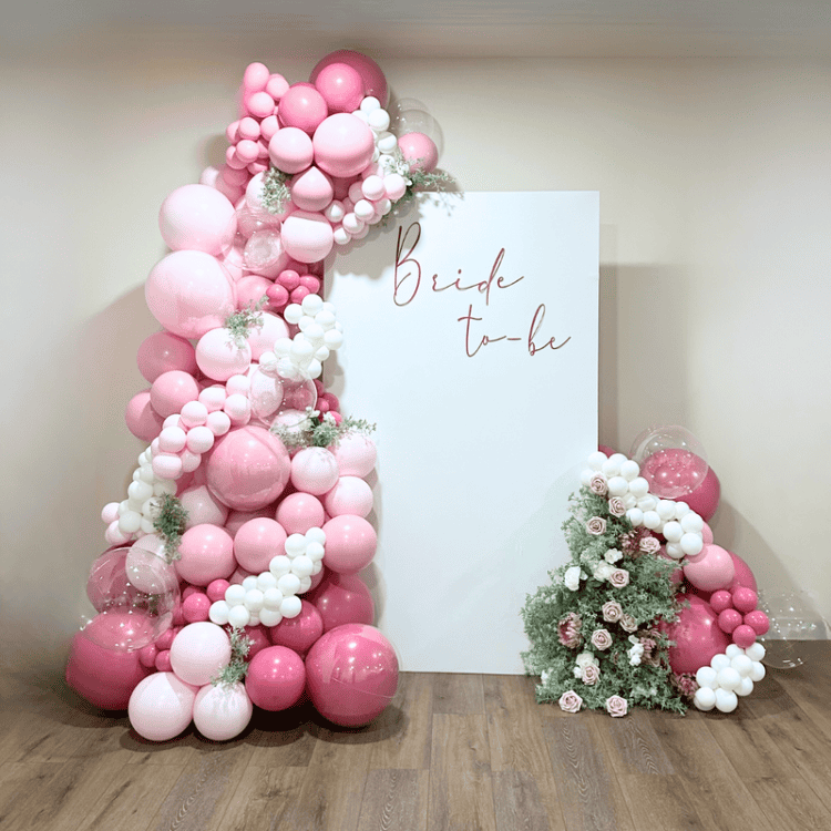 Pink and white organic balloon garland with Bride to Be sign and floral display