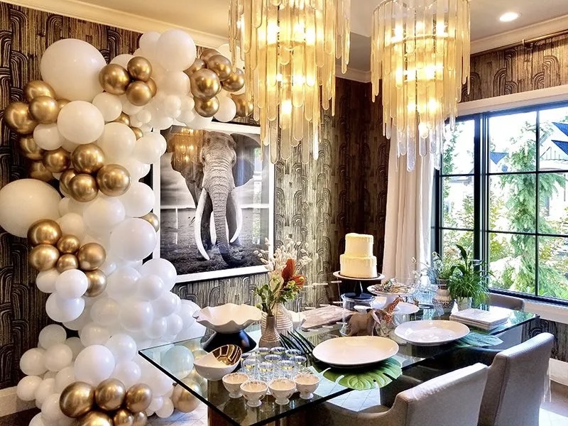 White and gold organic balloon garland framing an upscale dining setup