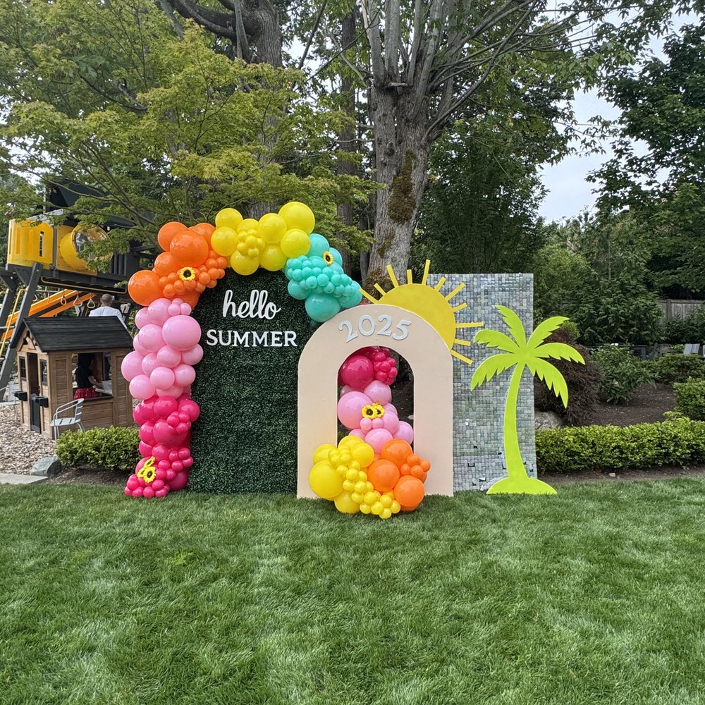 Hello Summer backdrop with 2025 arch, palm tree, and pink, yellow, orange, and teal balloons