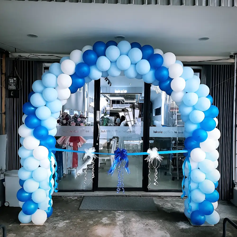 Light blue and dark blue classic balloon arch over a storefront entrance