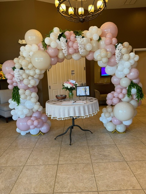 Pink and cream organic balloon full arch with cascading white florals for a wedding